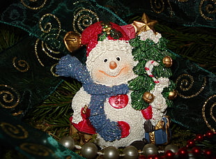 white and red ceramic snowman figurine
