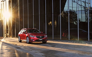 red Mazda SUV beside glass building during daytime HD wallpaper