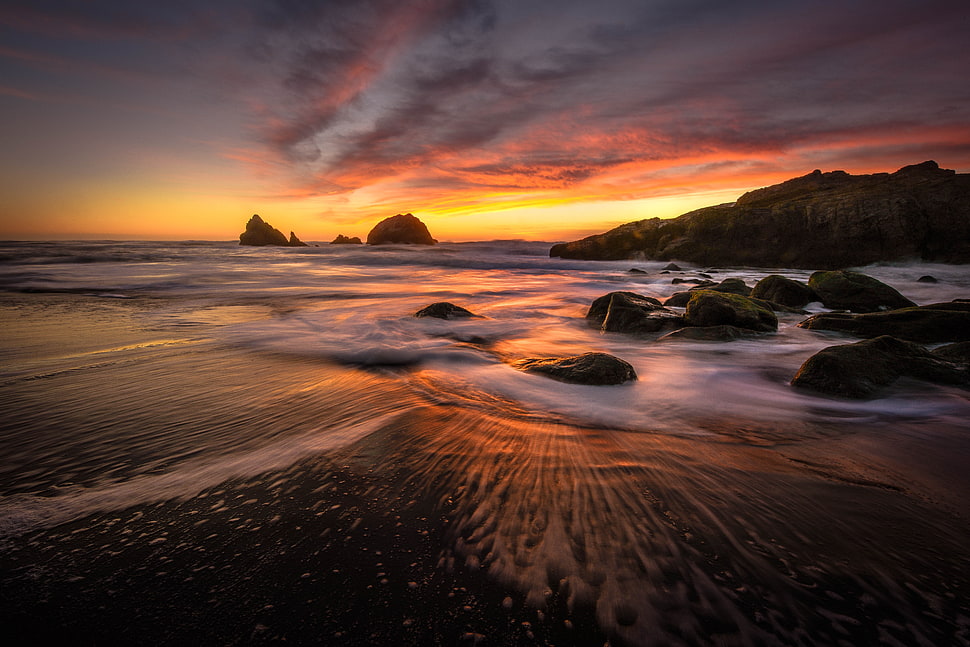 cloudy sky over rocks on shore HD wallpaper