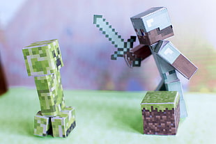 shallow focus photography of green and blue Minecraft figure
