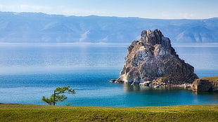 rock formation surrounded of body of water, river