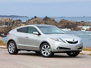 silver Acura coupe parked beside ocean view during daytime photo HD wallpaper
