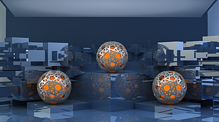 three silver-and-orange home decors