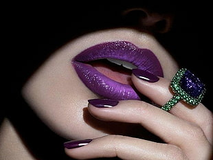person wearing green diamond embellished ring