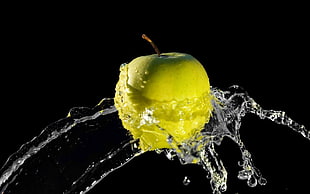 green apple with water splashes