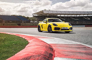 yellow Porsche 911 on race track