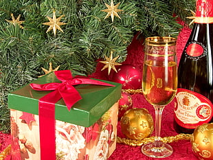 champagne glass near gift box and baubles