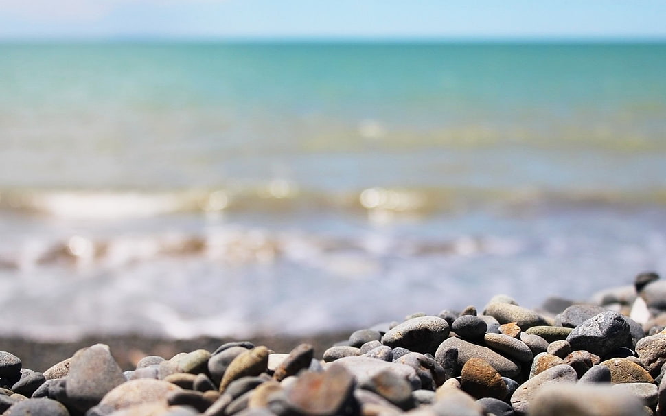close up photo of grey stones and sea waves HD wallpaper