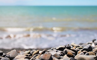 close up photo of grey stones and sea waves