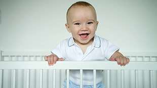 baby smiling standing on the crib HD wallpaper