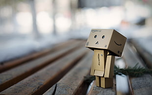 black and gray power bank, depth of field, Danbo, bench
