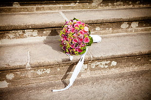 bouquet of flowers on gray concrete stairs