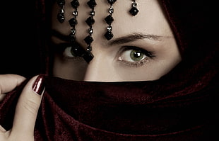 close up photography of woman wearing black hijab with black beaded head accessory