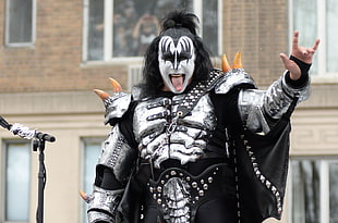 man wearing white and black costume dress taking picture in close-up during daytime