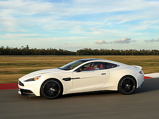 white Aston Martin coupe on roadway