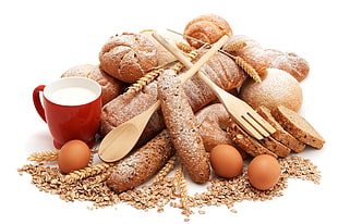still life photography of three organic eggs beside leavened bread and red ceramuc mug