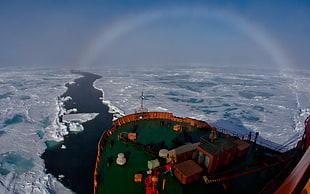 cargo boat near icebergs
