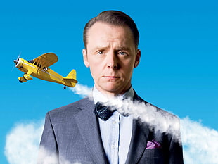 man wears gray suit and yellow airplane art