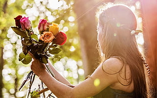 photo of woman holding bouquet of flower