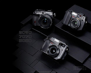 black Olympus 8080, 7070, and 5050 compact cameras