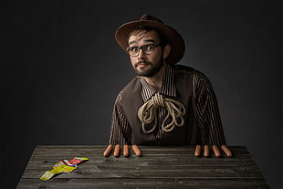 person wearing hat near wooden table