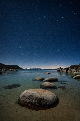 landscape photography of boulders on body of water during night time, lake tahoe HD wallpaper