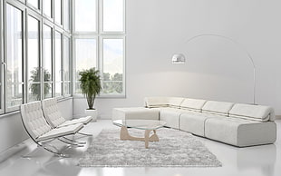 tufted white sectional sofa and two sofa chair with triangle glass-top table