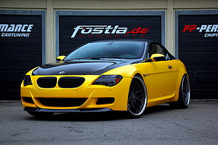 black and yellow BMW sports coupe