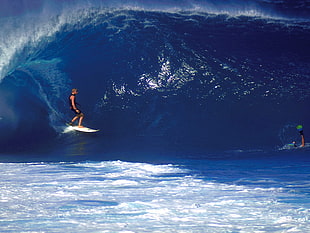 photo of man surfing during daytime