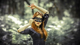 woman wearing gray masquerade mask