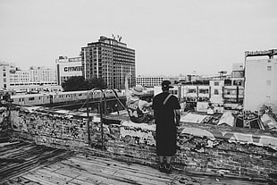 grayscale photo of two people, rooftops