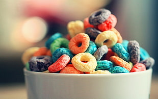 assorted-color cereals on white ceramic bowl