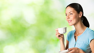 woman holding white teacup on her right hand and saucer and left hand HD wallpaper