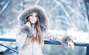 photography of woman wearing brown parka coat during winter season