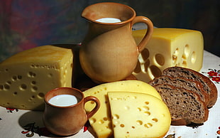 assorted Cheese and milk on brown ceramic milk cups