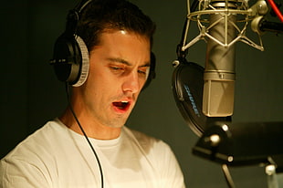 man in white shirt wearing headphones