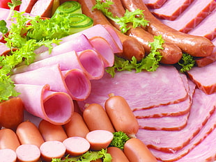 sausages and hams with green leaf vegetable