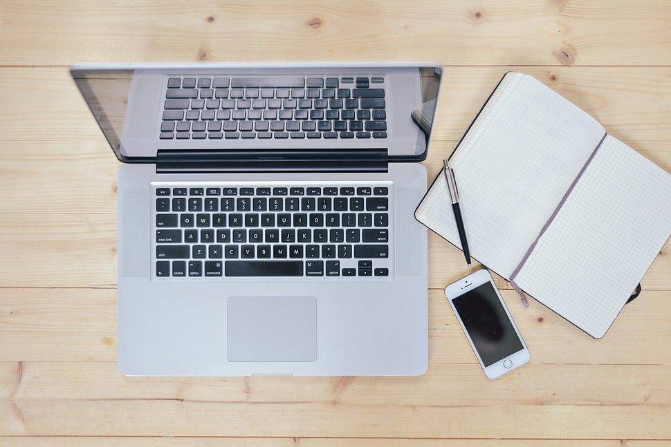 MacBook Pro near silver iPhone and pen HD wallpaper