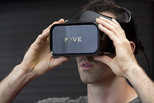 man using black fove VR