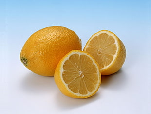 one whole yellow lemon fruit and sliced of lemon fruit HD wallpaper