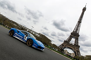 blue Ferrari 488 GTB parked near Eiffel Tower, Paris