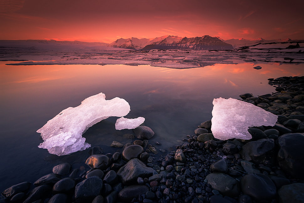 body of water with rocks and ice HD wallpaper