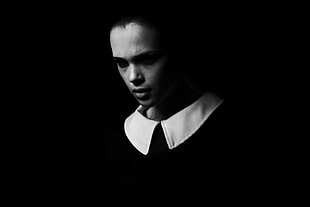 woman wearing white collar shirt in dark room