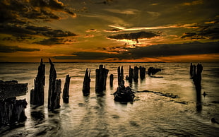rocks on sea during sunset