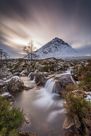 shallow focus photo of white mountain in front of running water, highlands