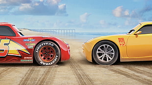 Lightning McQueen and yellow car on brown sand