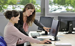 woman pointing on computer monitor during daytime HD wallpaper