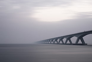 landscape photography of bridge near body of water HD wallpaper