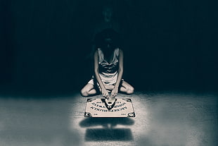 woman playing Ouija board