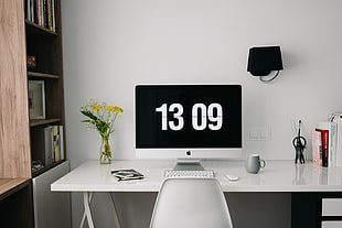 white iMac on table beside bookshelves HD wallpaper